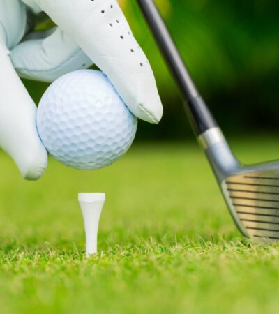 Close up view of golf ball on tee on golf course